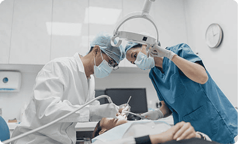Dental professionals performing surgery in a modern clinic setting.